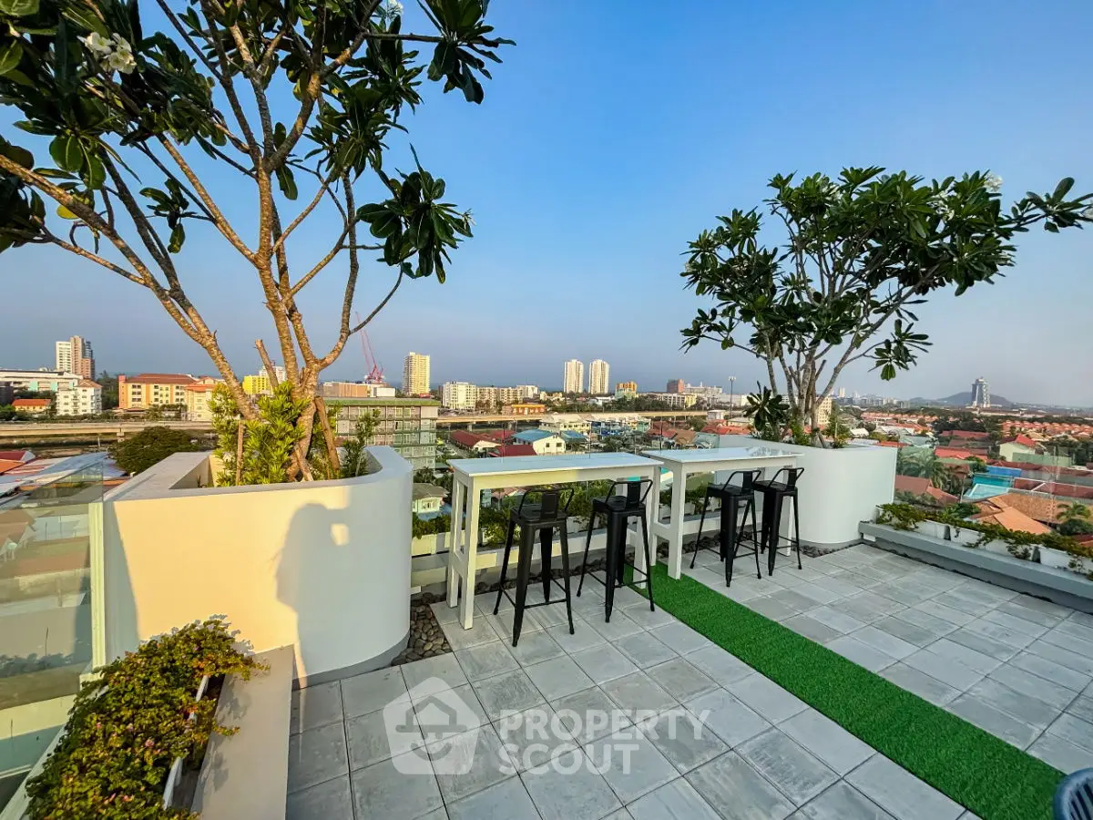 Stunning rooftop terrace with panoramic city views and modern outdoor seating.