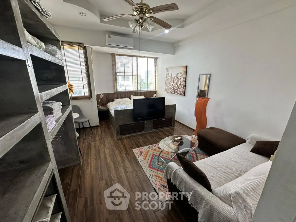 Chic studio apartment with modern decor, featuring cozy living area and stylish furnishings.