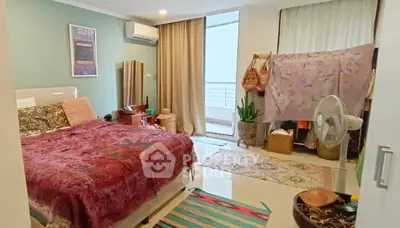 Cozy bedroom with vibrant decor and balcony access in modern apartment
