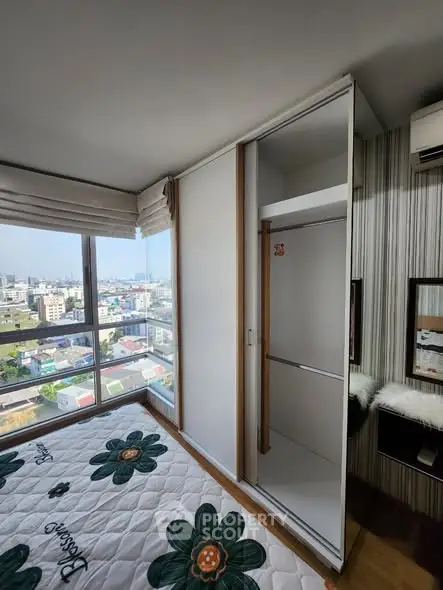 Modern bedroom with city view and built-in wardrobe
