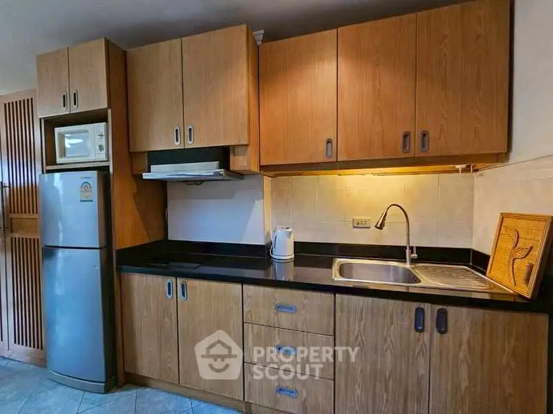 Modern kitchen with wooden cabinets and stainless steel appliances