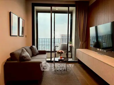 Modern living room with large windows and city view, featuring a cozy sofa and wall-mounted TV.