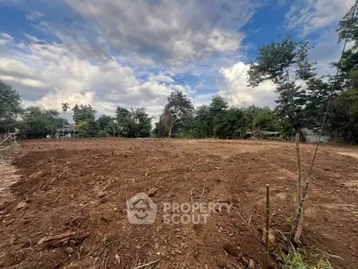 Expansive plot of land with clear skies, perfect for development opportunities.