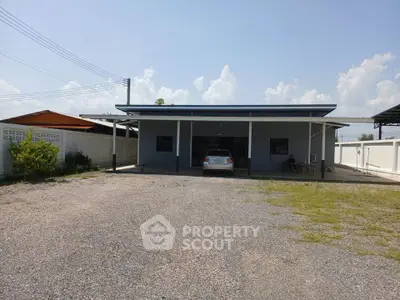Spacious single-story home with large driveway and carport, perfect for family living.