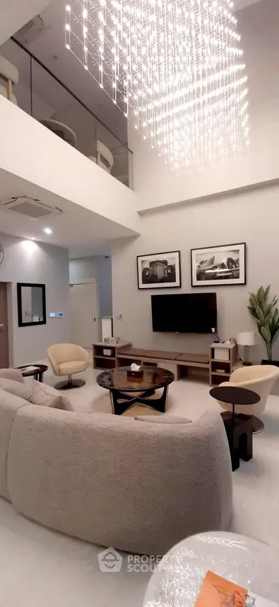 Luxurious modern living room with high ceiling and elegant chandelier