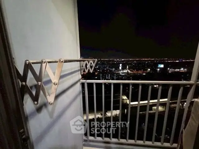 Stunning night cityscape view from a high-rise balcony with sleek railing design.