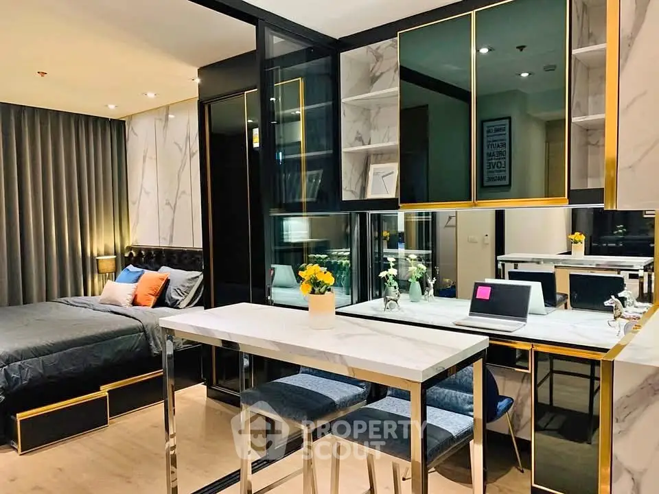 Luxurious modern studio apartment with elegant decor and stylish furniture, featuring a cozy bed and chic dining area.