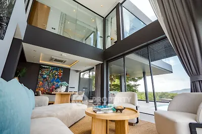 Luxurious modern living room with floor-to-ceiling windows and stunning outdoor view