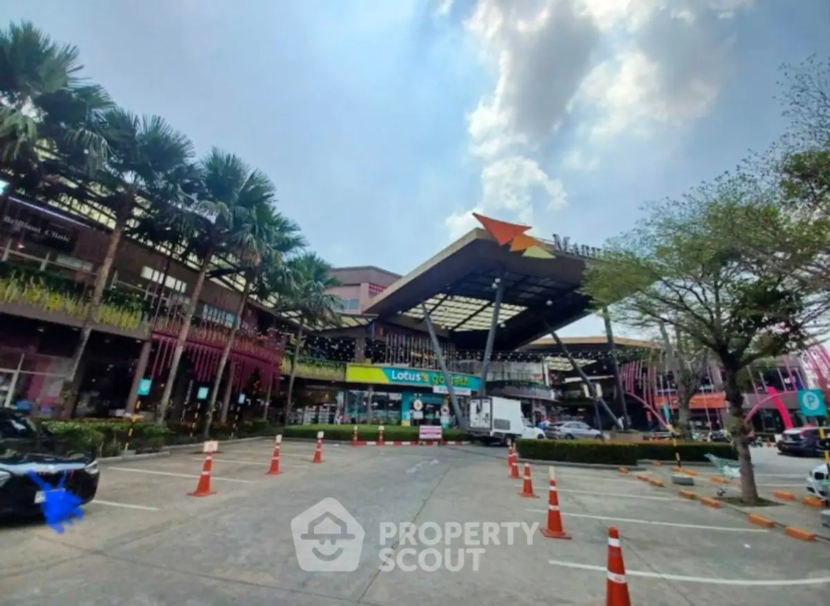 Modern commercial complex with vibrant architecture and ample parking space.