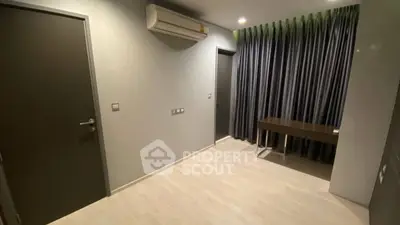 Modern minimalist room with air conditioning and sleek curtains, ideal for a study or office space.