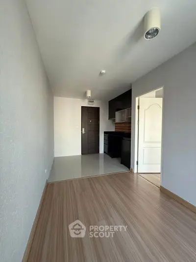 Modern apartment interior with sleek kitchen and wooden flooring, perfect for urban living.