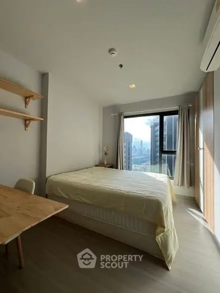 Modern bedroom with city view, featuring cozy bed and minimalist decor.