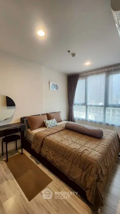 Modern bedroom with large window and stylish decor in urban apartment