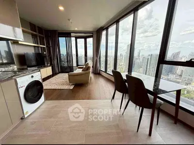 Stunning high-rise apartment with panoramic city views, featuring modern open-plan living and dining area.