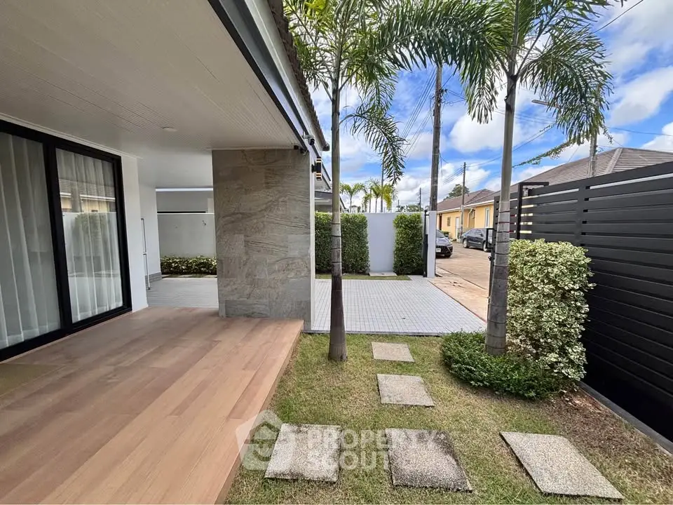 Modern home exterior with lush garden and spacious patio