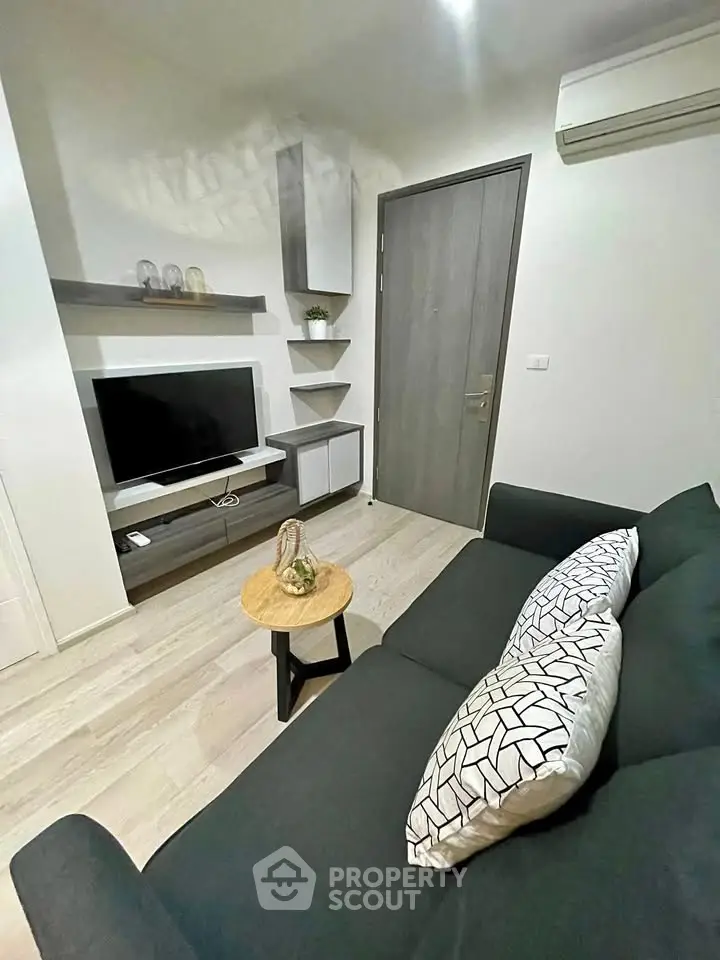 Modern living room with sleek furniture and wall-mounted TV, perfect for cozy relaxation.