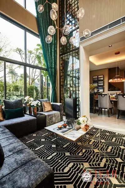 Luxurious living room with high ceilings, floor-to-ceiling windows, and modern decor, seamlessly connected to an elegant dining area.