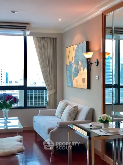 Elegant living room with modern decor and city view, featuring cozy seating and stylish artwork.