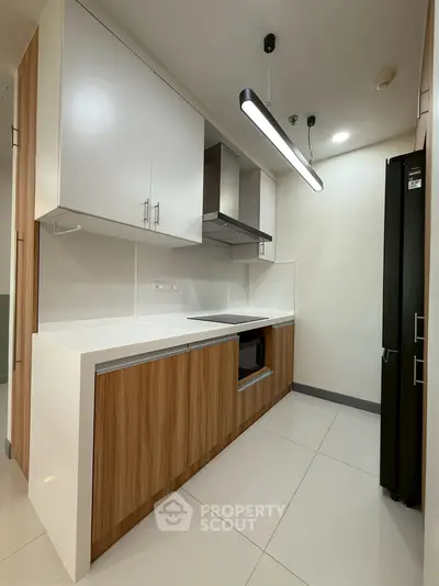 Modern kitchen with sleek cabinetry and built-in appliances in a stylish apartment.