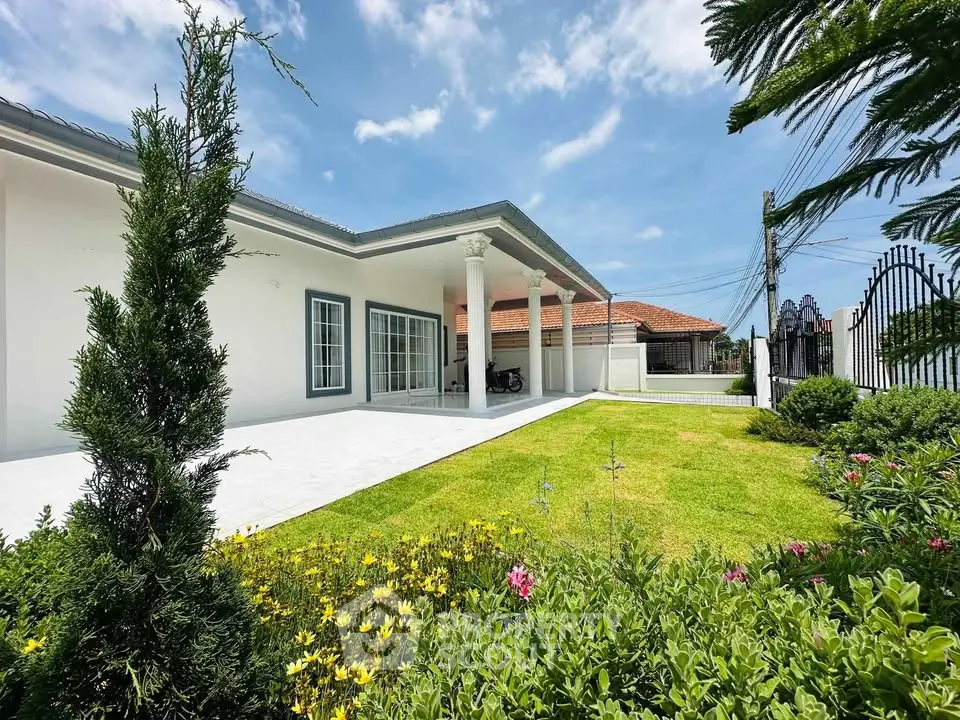 Stunning exterior view of a modern home with lush garden and spacious patio, perfect for outdoor living.