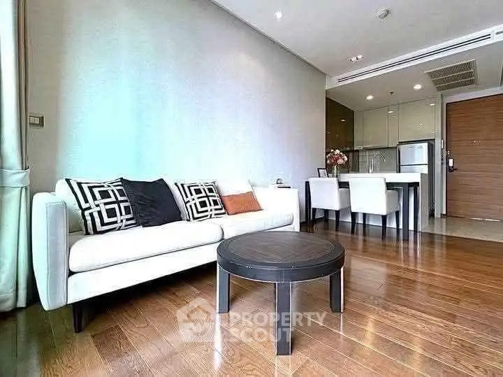 Modern living room with stylish decor and open kitchen layout in a contemporary apartment.