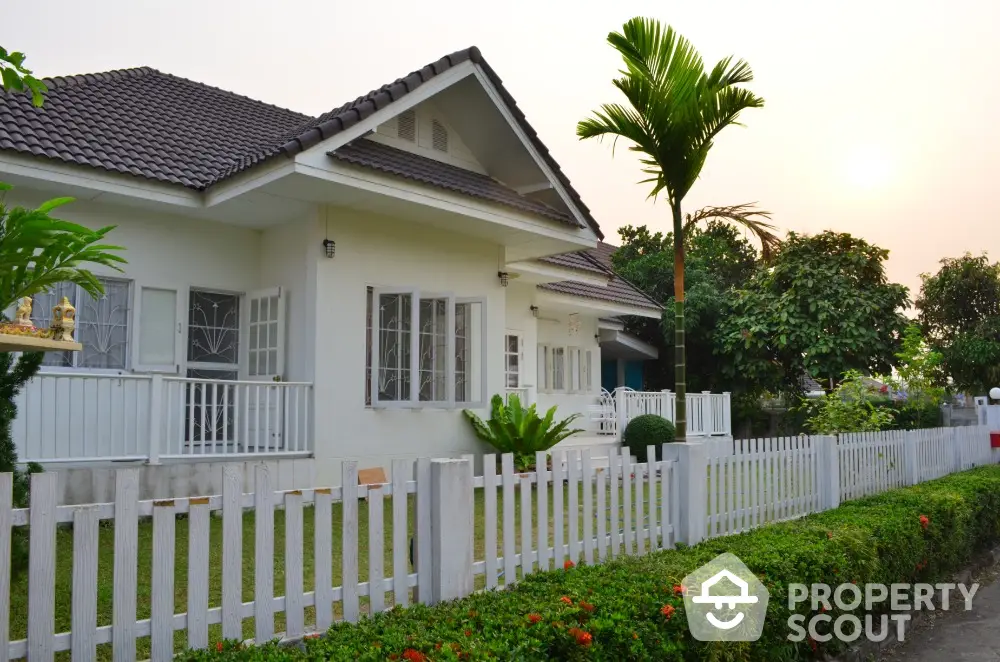 Charming suburban home with lush garden and white picket fence, perfect for family living.