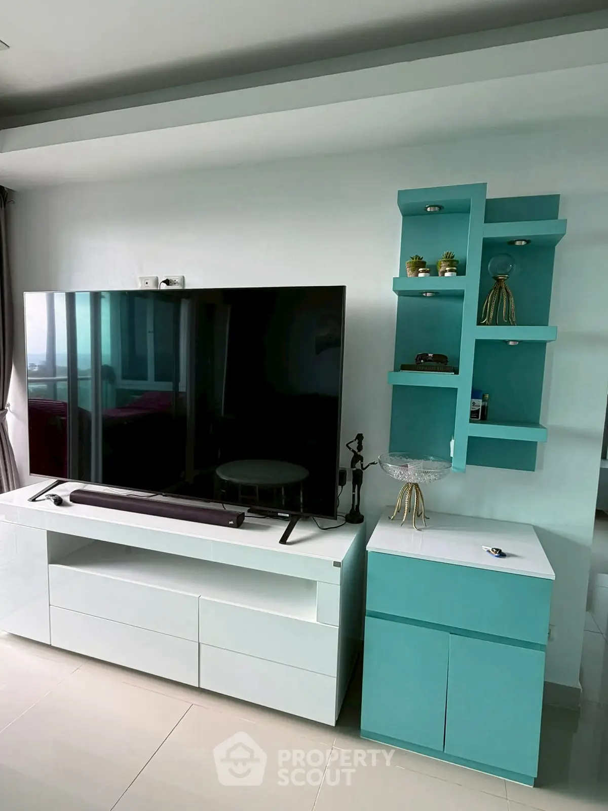 Modern living room with sleek TV unit and stylish shelving