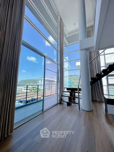 Stunning high-ceiling living room with large windows and scenic view
