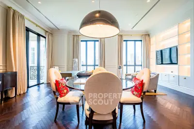 Luxurious living room with elegant decor and city view, featuring a stylish dining area and large windows.