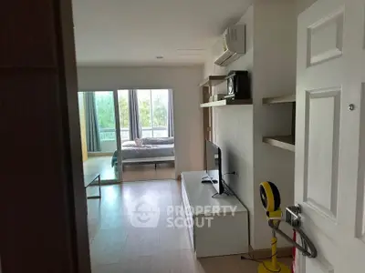 Modern apartment interior with open living space and bedroom view