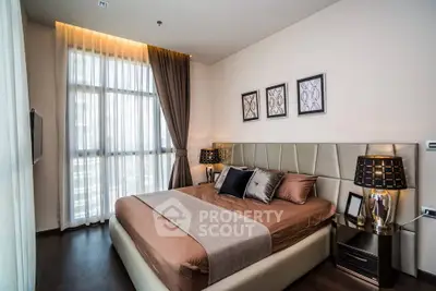 Luxurious bedroom with elegant decor and large window in modern apartment
