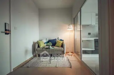 Cozy living room with modern decor and adjacent kitchen area