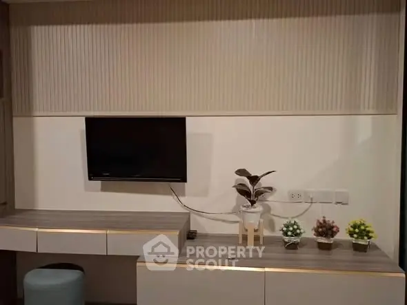Modern living room with wall-mounted TV and stylish decor