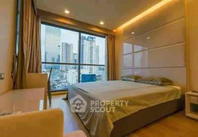 Luxurious bedroom with stunning city view and modern decor in high-rise apartment.