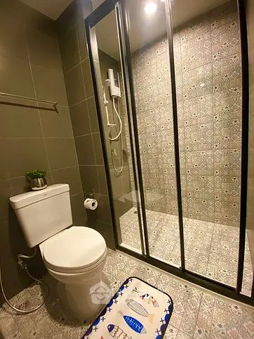 Modern bathroom with stylish tiles and glass shower enclosure