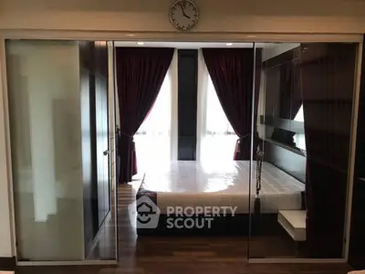 Modern bedroom with glass sliding doors and elegant dark curtains