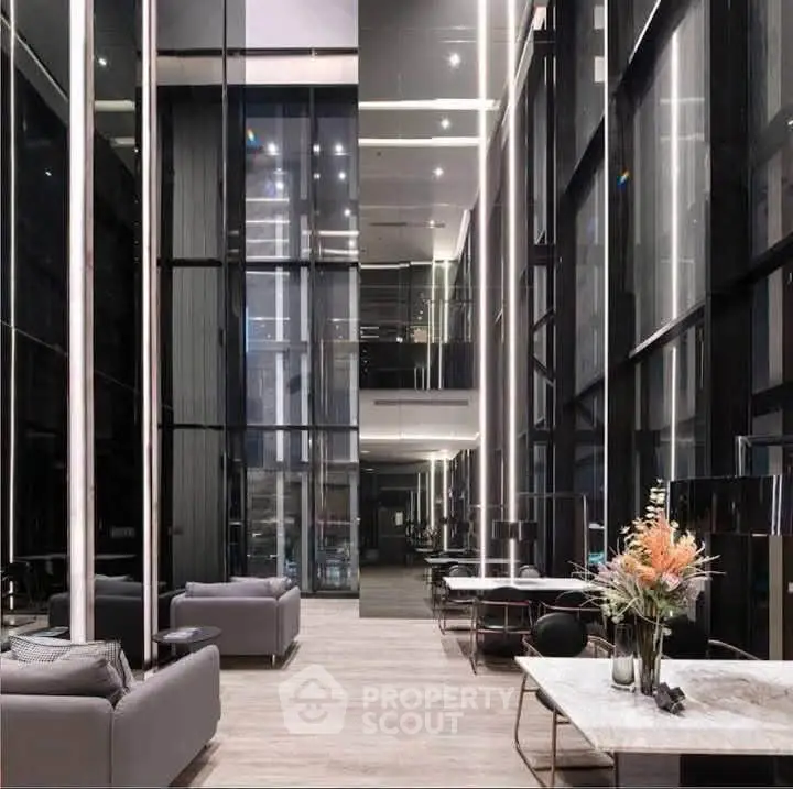 Luxurious modern lobby with high ceilings and elegant decor in a contemporary building.