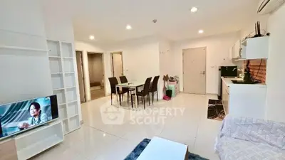 Spacious modern living room with open kitchen and dining area, perfect for entertaining.
