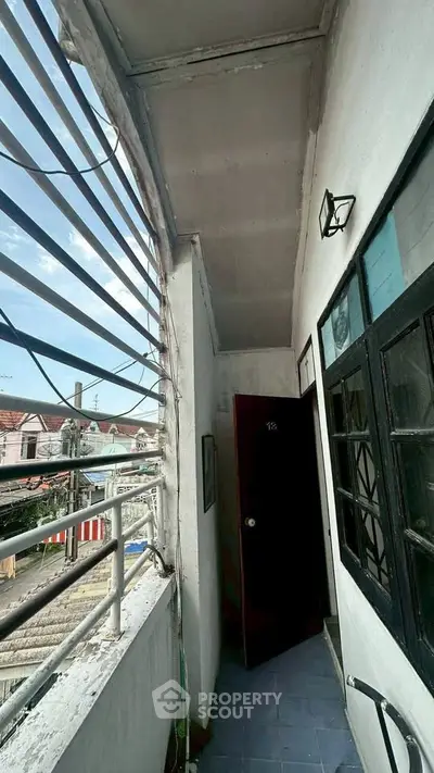 Charming balcony with urban view and unique architectural details, perfect for city living enthusiasts.