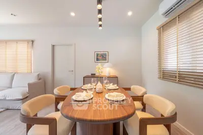Elegant dining room with modern wooden table and cozy chairs, perfect for family gatherings.