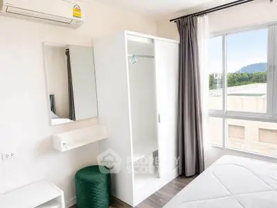 Bright bedroom with modern white wardrobe and large window view