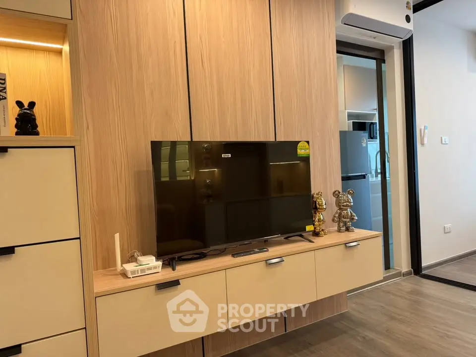 Modern living room with stylish TV setup and open kitchen view