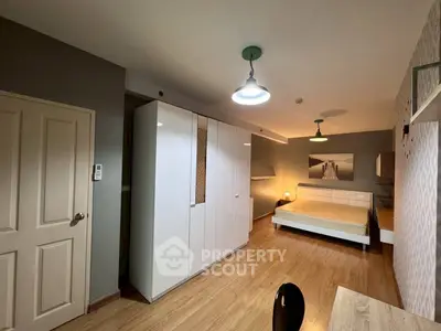 Spacious bedroom with modern decor and ample storage space