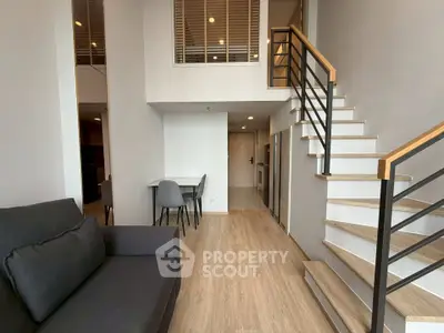 Modern duplex apartment with stylish staircase and cozy living area