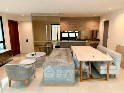 Modern living room with stylish furniture and open kitchen layout, perfect for contemporary living.