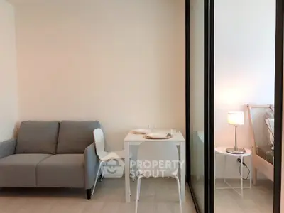 Modern living room with cozy sofa and dining area in stylish apartment