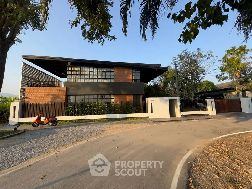 Modern architectural home with sleek design and lush surroundings, featuring a spacious driveway and contemporary facade.