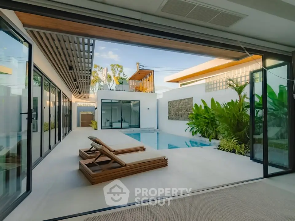 Luxurious modern home with private pool and stylish outdoor lounge area.