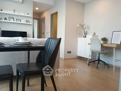 Modern open-plan living and dining area with stylish decor and natural light.