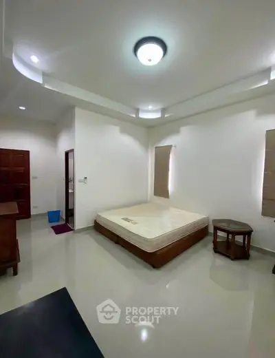 Spacious bedroom with modern lighting and minimalist decor